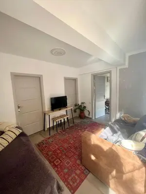 a living room with a couch and a table at A Detached Floor in Parekklisha