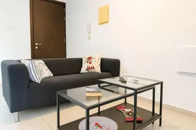 a living room with a couch and a glass table at Old town studio in Limassol