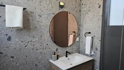 a bathroom with a sink and a mirror at STAY Lima Soul Apartment in Limassol