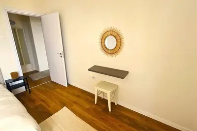 a room with a table and a mirror on a wall at Molos Beachfront City-Centre in Limassol