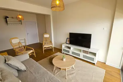 a living room with a couch and a flat screen tv at Molos Beachfront City-Centre in Limassol