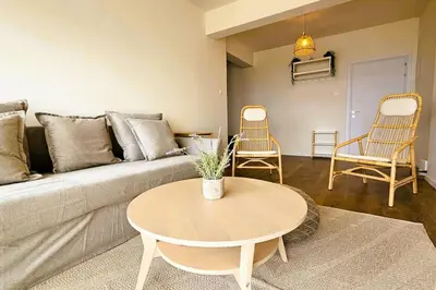 a living room with a couch and a table and chairs at Molos Beachfront City-Centre in Limassol