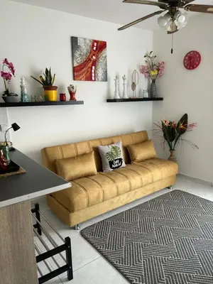 a living room with a couch and a table at Nikoletta apartman in Limassol