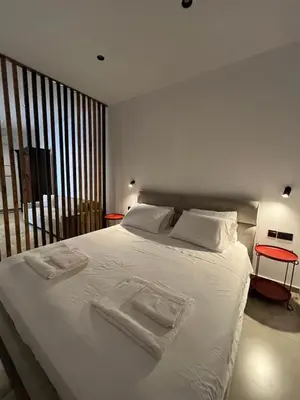 a bedroom with a white bed with towels on it at Calavato Cottage in Kalavasos
