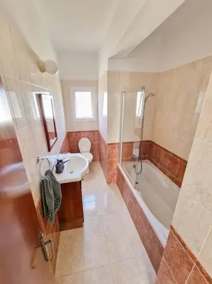 a bathroom with a sink and a tub and a toilet at Villa Malama in Paralimni