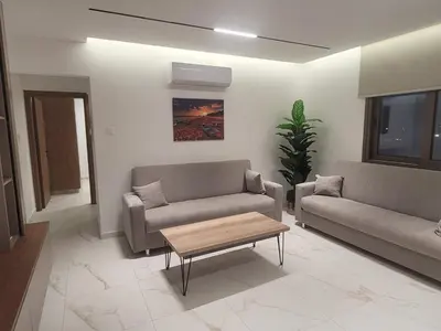 a living room with two couches and a coffee table at IOLENA Seaview Apartment in Pyla