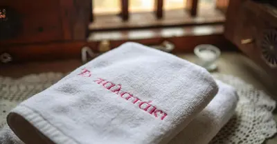 a towel with a baseball on it sitting on a bed at Vasilikis House in Kalopanayiotis