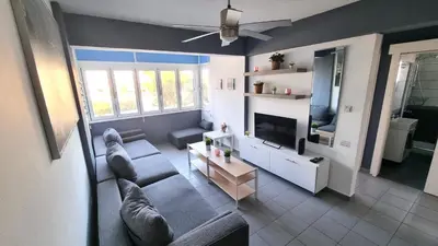 a living room with a couch and a tv at Beachside Comfort - 2Br Apt,5 Min to the Beach in Larnaka