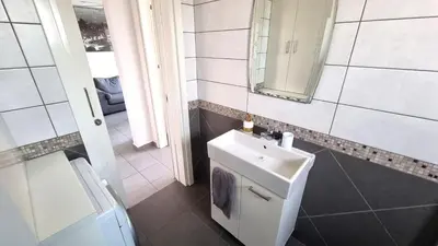 a bathroom with a sink and a mirror at Beachside Comfort - 2Br Apt,5 Min to the Beach in Larnaka