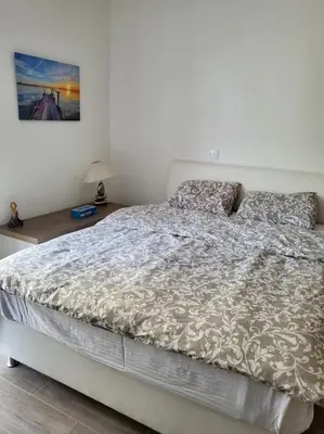 a bedroom with a bed with a comforter on it at Limassol mountain and sea views in Limassol