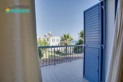 a door to a balcony with a view of the ocean at Ammos Villa 20 Side Seaview in Larnaka
