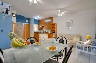 a dining room with a table with a bowl of fruit on it at Ammos Villa 20 Side Seaview in Larnaka