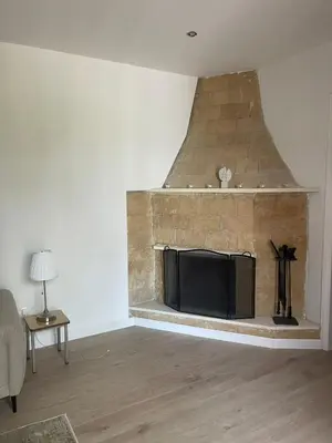a living room with a fireplace with a flat screen tv at Omodos Serenity House in Omodos