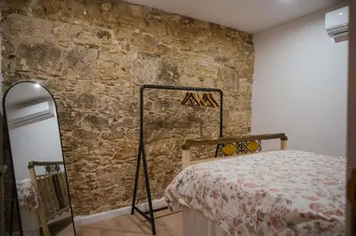 a bedroom with a brick wall and a bed at Omodos Serenity House in Omodos