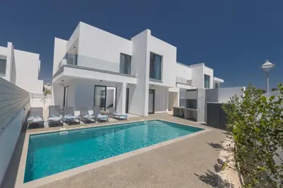 a white villa with a swimming pool in front of it at Semeli Villa 8 in Protaras