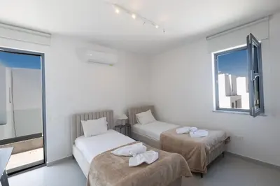 a room with two beds and a window at Semeli Villa 8 in Protaras