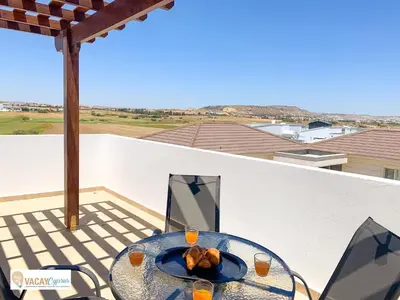 a table with a plate of food on a balcony at Villa Orash in Larnaka