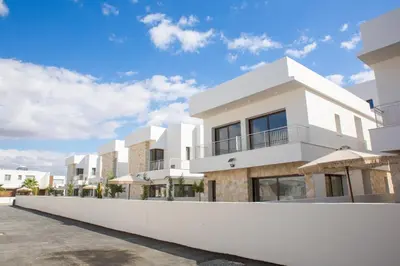 a white house with a white wall at LIV & CO Suites & Villas in Voroklini