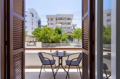 a table and chairs on a balcony with a view at Aura 2-Bedroom Apartment in Larnaca in Larnaka