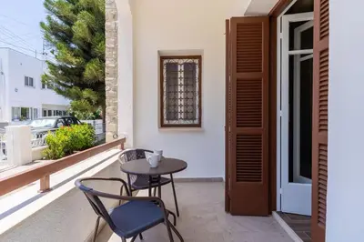 a patio with a table and chairs on a balcony at Aura 2-Bedroom Apartment in Larnaca in Larnaka