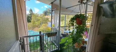 an open balcony with a view of a pool at Kyperounta Troodos mountain house in Limassol