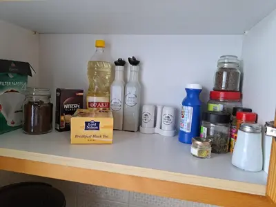 a shelf with bottles and other items on it at Kyperounta Troodos mountain house in Limassol