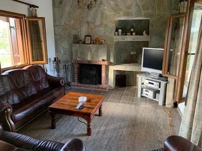 a living room with a couch and a tv and a fireplace at Mountain View! Cosy life in Nicosia