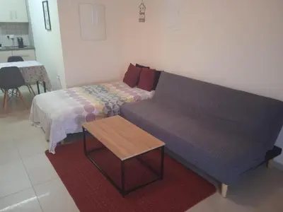 a living room with a couch and a bed at Xylophagou Rest and Relax 4 Top floor Big Balcony 1 bedroom apartment in Xylophaghou