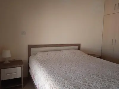 a bedroom with a bed and a dresser and a night stand at Xylophagou Rest and Relax 4 Top floor Big Balcony 1 bedroom apartment in Xylophaghou