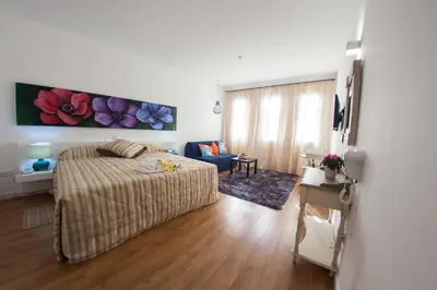 a bedroom with a bed and a living room at Operetta House in Larnaka