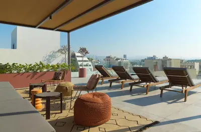 a row of chairs and tables on a roof at Alinea Diono Historic Center in Limassol