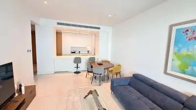 a living room with a blue couch and a table at Del Mar 2 Bedroom Deluxe Seaside 'A' Residence in Limassol