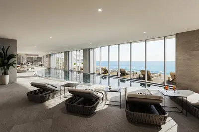 a living room with a pool and chairs and a table at Del Mar 2 Bedroom Deluxe Seaside 'A' Residence in Limassol