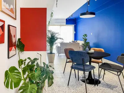 a dining room with blue walls and plants at Terrazzo style 2 bedroom 2bathroom Apartment in Larnaka