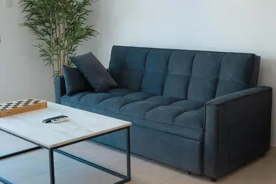 a blue couch and a coffee table in a living room at Maestro Sunrise View in Larnaka