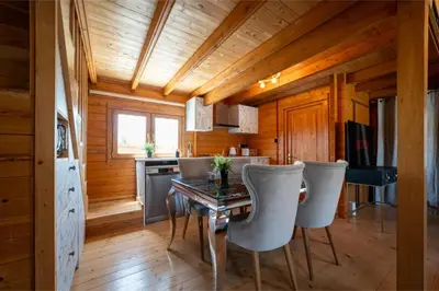 a kitchen with a table and chairs in a cabin at Ktima To Alliotiko - Lofou 1 in Lofou