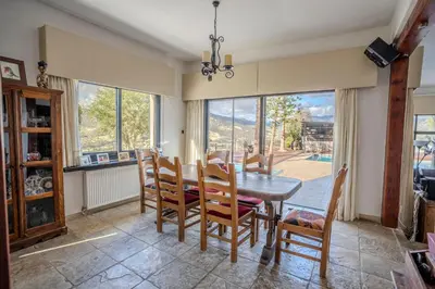 a dining room with a table and chairs and a window at Great property - amazing views in Limassol