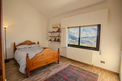 a bedroom with a bed and a large window at Great property - amazing views in Limassol
