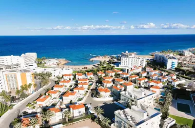 an aerial view of a city and the ocean at Villa Anemona - 100m from Pernera Beach in Protaras