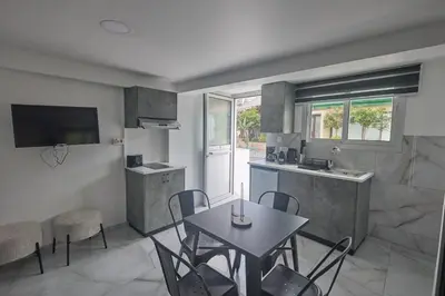 a kitchen and dining room with a table and chairs at Gold Emerging Villas Ltd Apart 1 in Ayia Napa