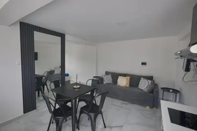 a living room with a couch and a table and chairs at Gold Emerging Villas Ltd Apart 1 in Ayia Napa