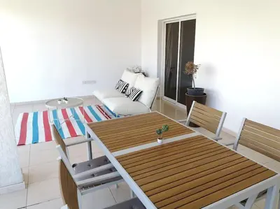 a living room with a table and a couch at Yippee! at Ermou Square Amazing Location View in Larnaka
