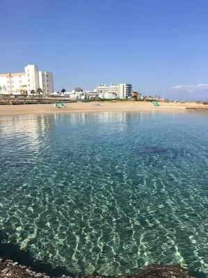 a body of water with a beach and buildings at Ivory Suite at Polyxenia - Tourism licence 03125 in Protaras