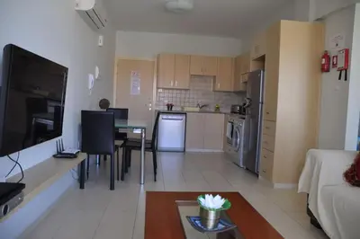 a living room and kitchen with a couch and a table at Ivory Suite at Polyxenia - Tourism licence 03125 in Protaras