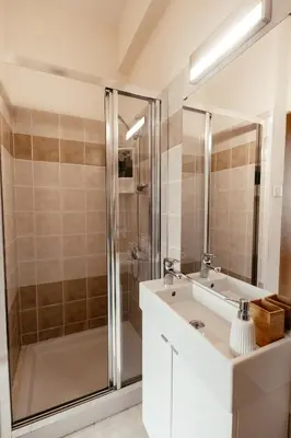 a bathroom with a white sink and a shower at Leah's Deluxe Villa in Tersephanou
