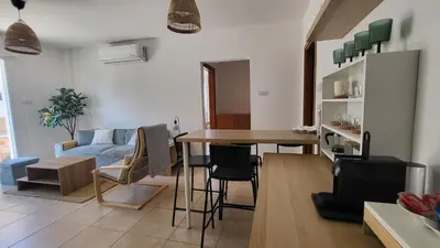 a living room with a table and a couch at Mythical Sands resort - Hana in Paralimni