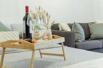a living room with a table with a bottle of wine at Cozy Studio Apt - Tourist Area Collection in Limassol