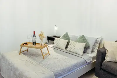 a living room with a couch and a table at Cozy Studio Apt - Tourist Area Collection in Limassol