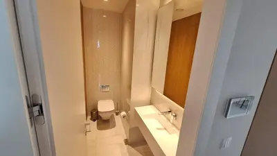 a white bathroom with a toilet and a sink at Del Mar 2 Luxe Bedroom 'C' Highrise Residence in Limassol