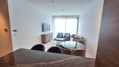 a room with a table and chairs and a living room at Del Mar 2 Luxe Bedroom 'C' Highrise Residence in Limassol